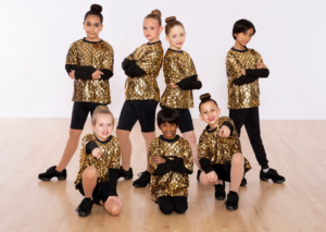 Boy and Girl Hip hop Students posed in their gold Dance Recital Costume